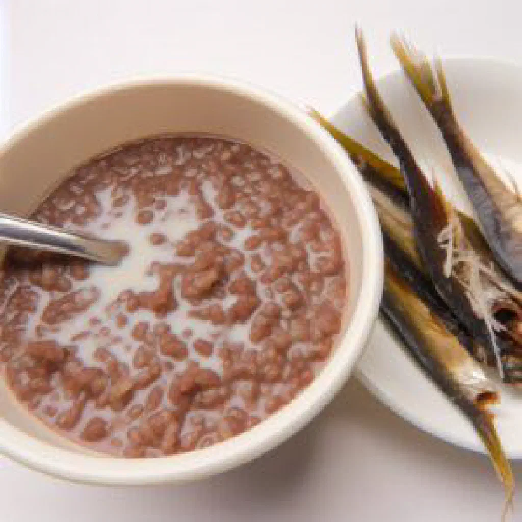 A warm bowl of champorado chocolate rice porridge drizzled with condensed milk