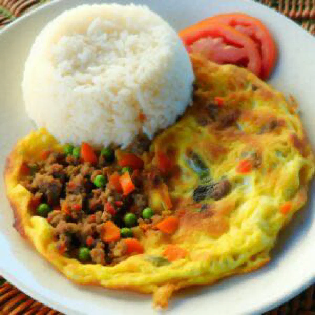 Golden Filipino torta omelette with minced meat and vegetables on a plate