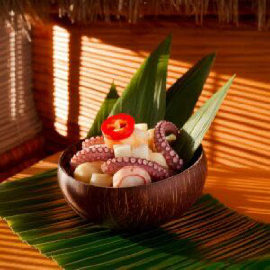 Bowl of vaisalo sago coconut pudding topped with fresh tropical fruit