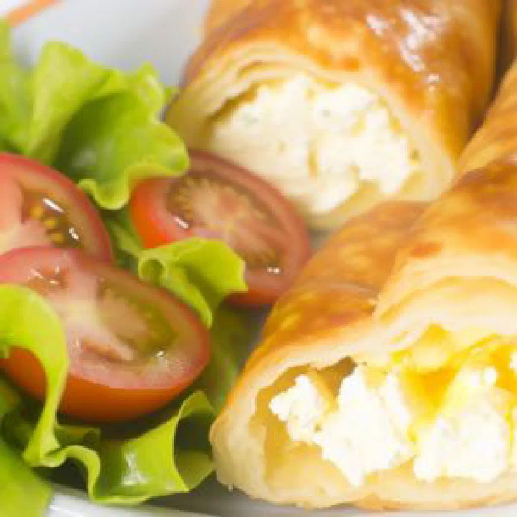 Golden fried Maslenica pastries filled with quark and fresh herbs, served with yoghurt