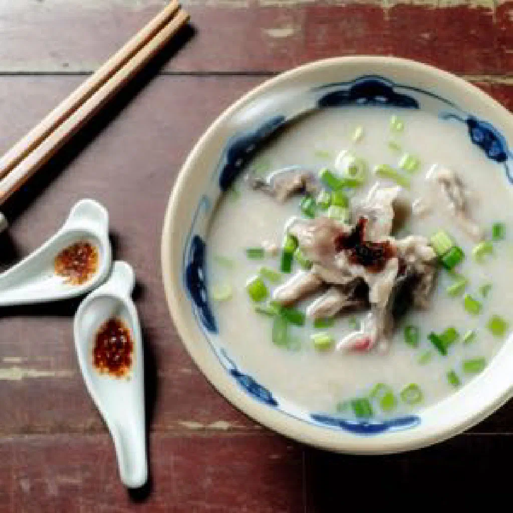 Bowl of Singapore frog porridge topped with fresh coriander