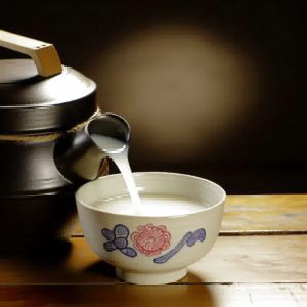 A bowl of milky white makgeolli rice wine served chilled