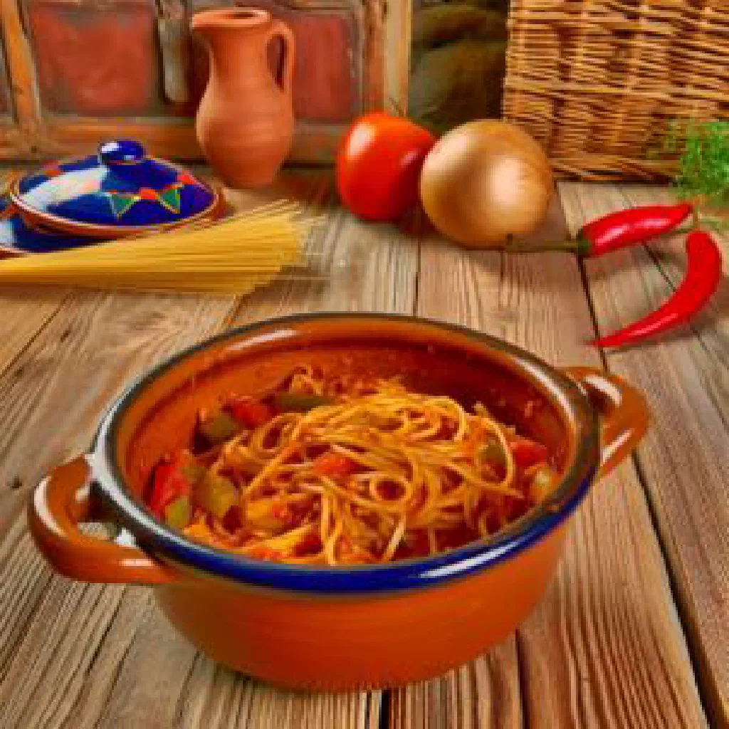 Fideos a la cazuela with seafood and peppers in an earthenware pot