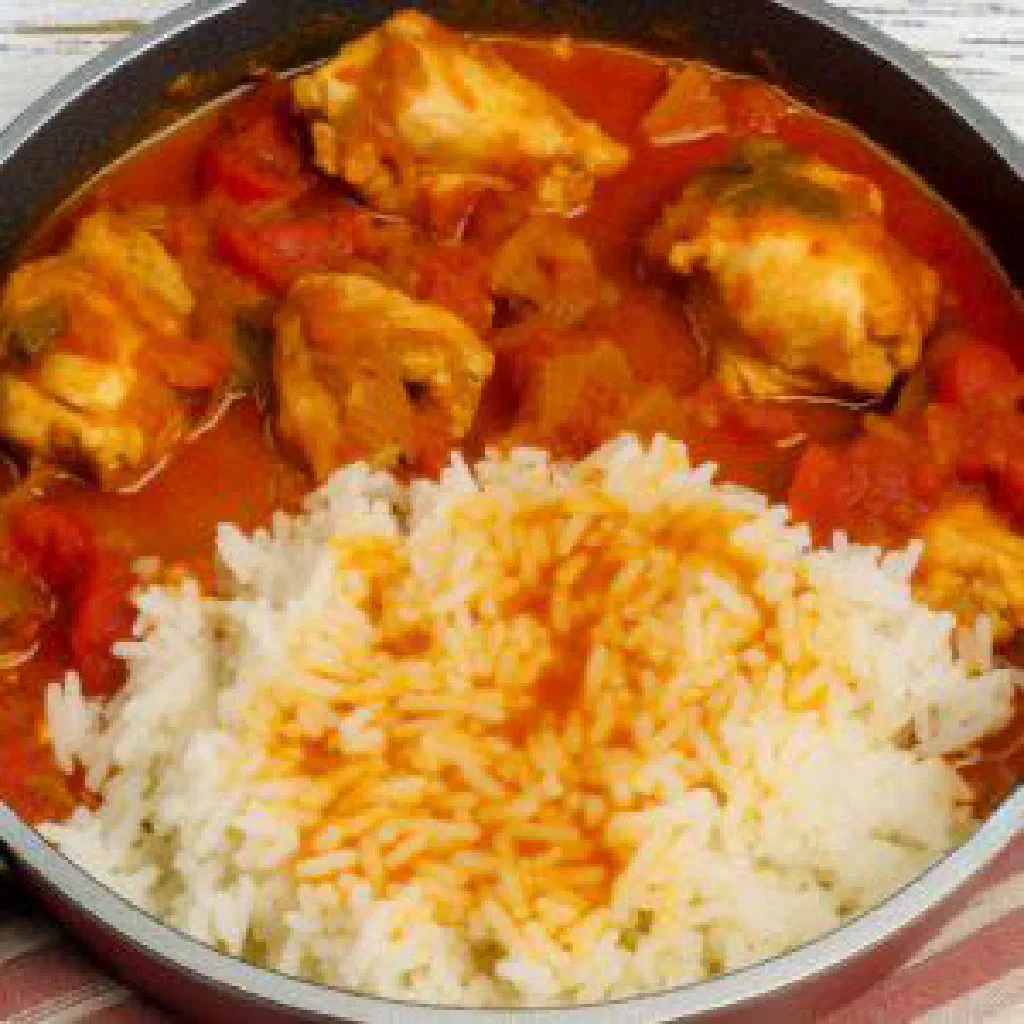 Rijsttafel spread with fragrant rice, spiced chicken and small side dishes