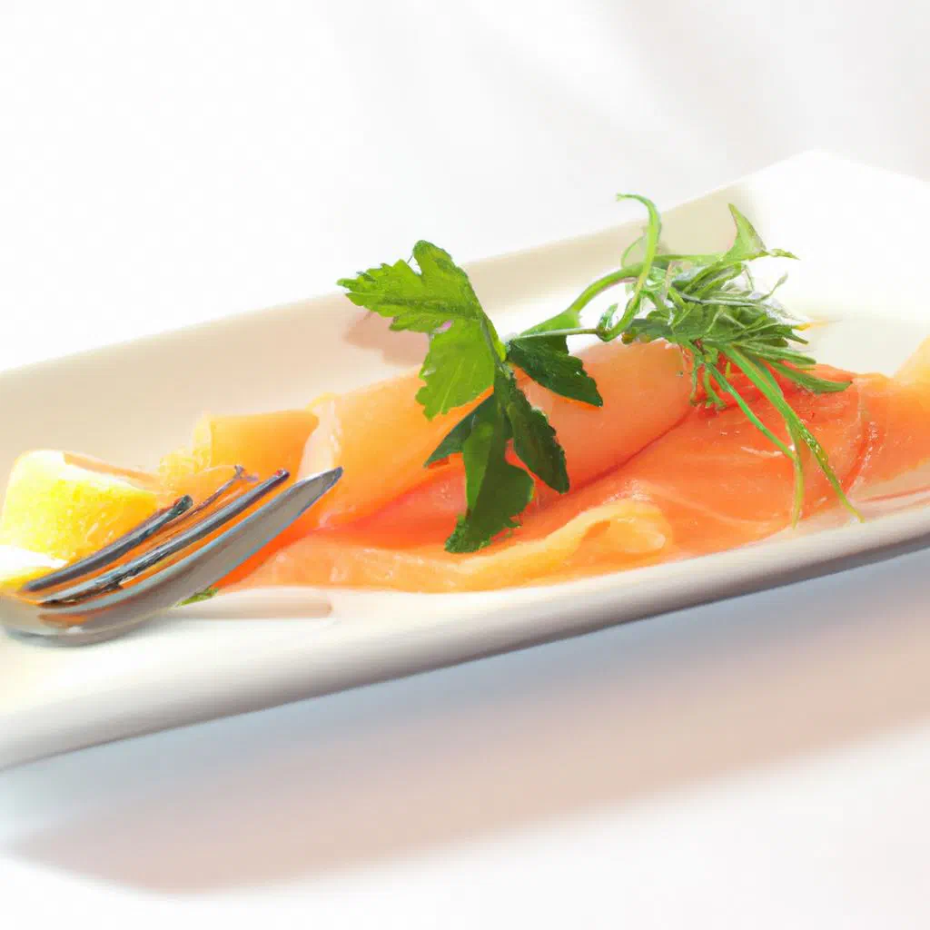 Thinly sliced dill-cured gravlax with lemon on a serving plate