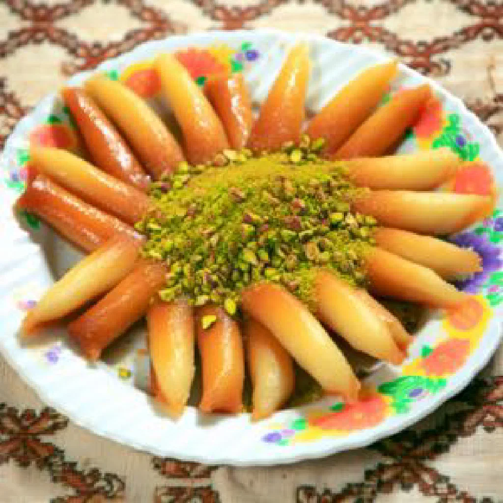 Golden Asabe Zainab pastry rolls drizzled with syrup and topped with chopped pistachios