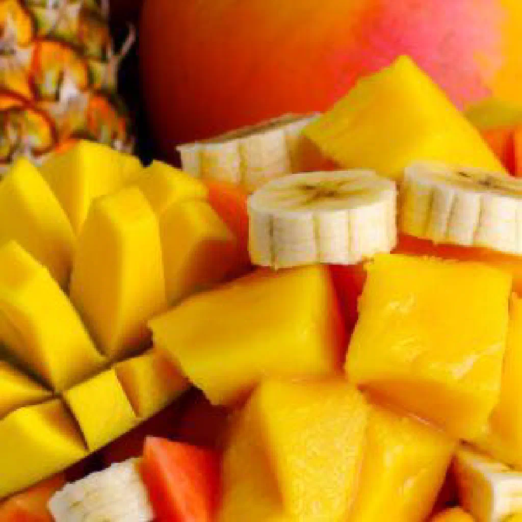 Colourful bowl of tropical fruit salad garnished with fresh mint