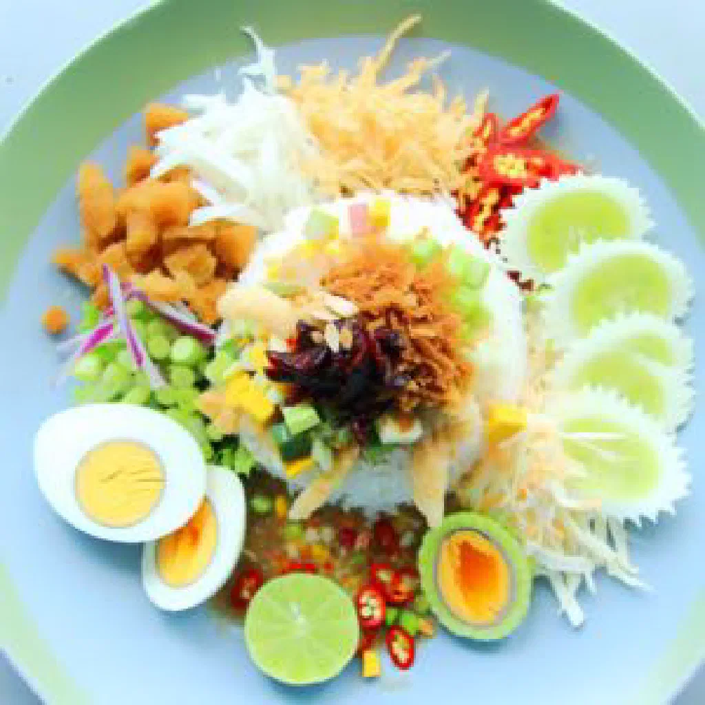 Colourful Thai khao yam rice salad with herbs, vegetables and toasted coconut