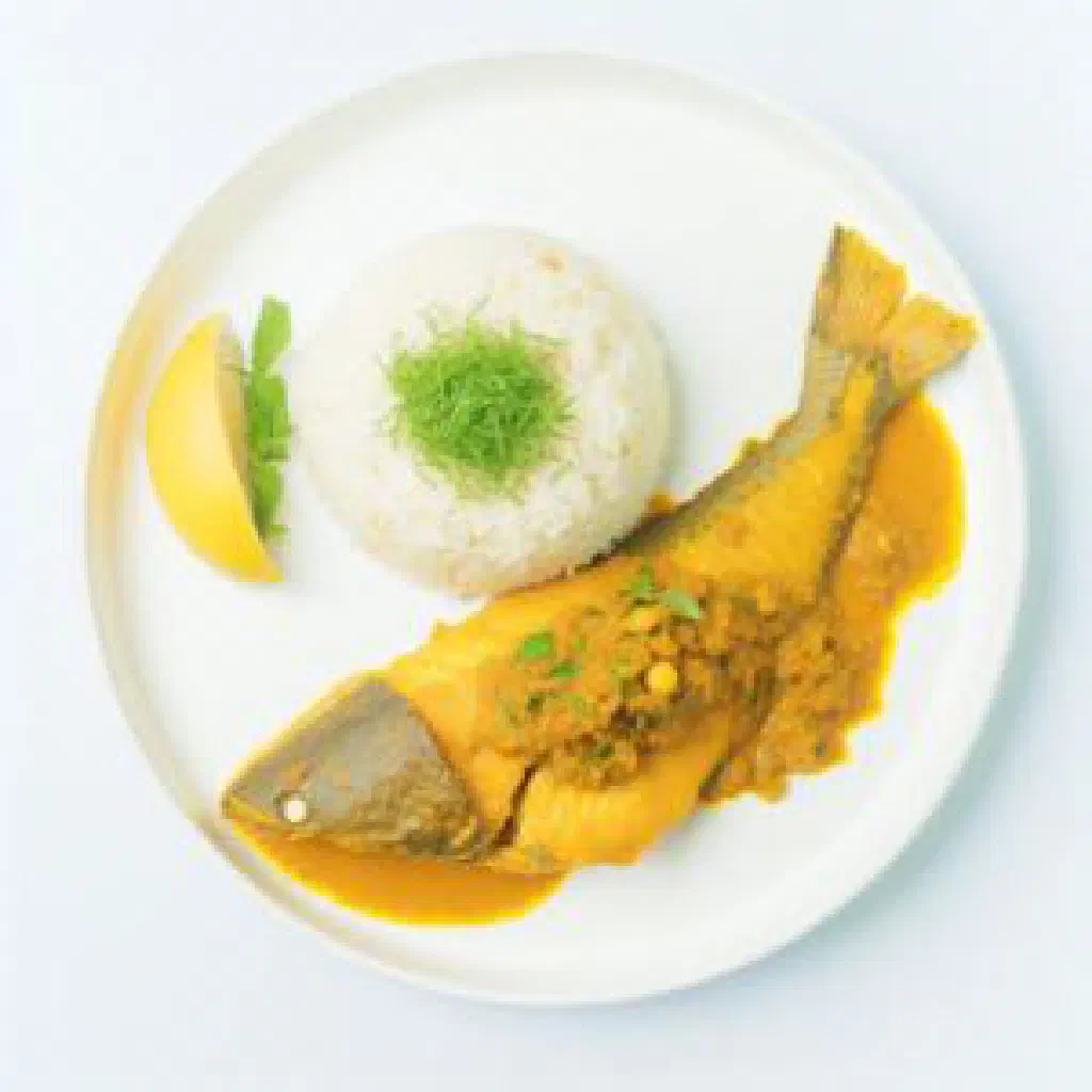 Spicy Thai stir-fried catfish in red curry sauce garnished with basil