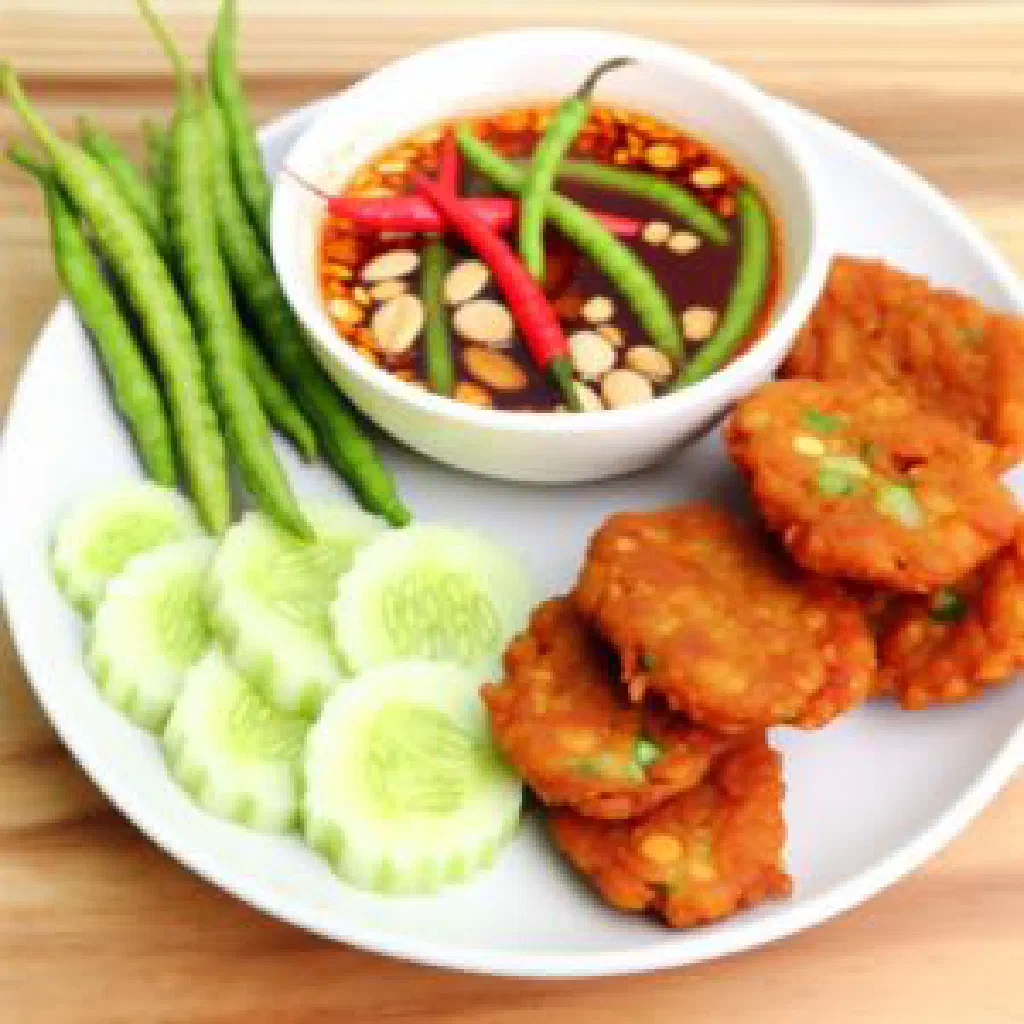 Golden Thai fish cakes garnished with fresh coriander and chilli