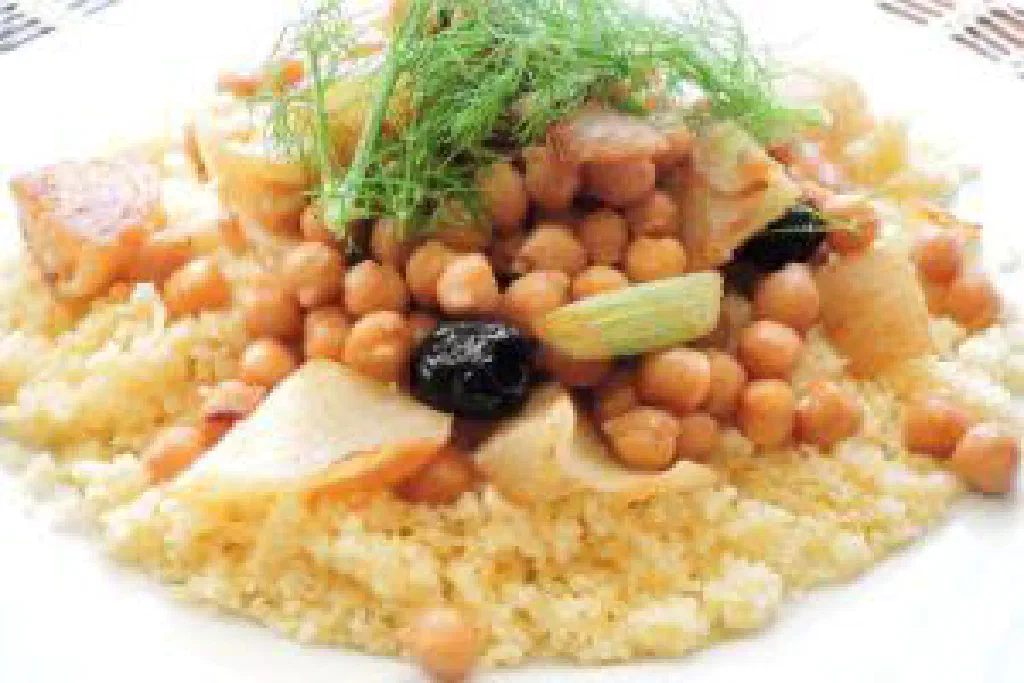 Fluffy Tunisian couscous with vegetables and spices in a bowl