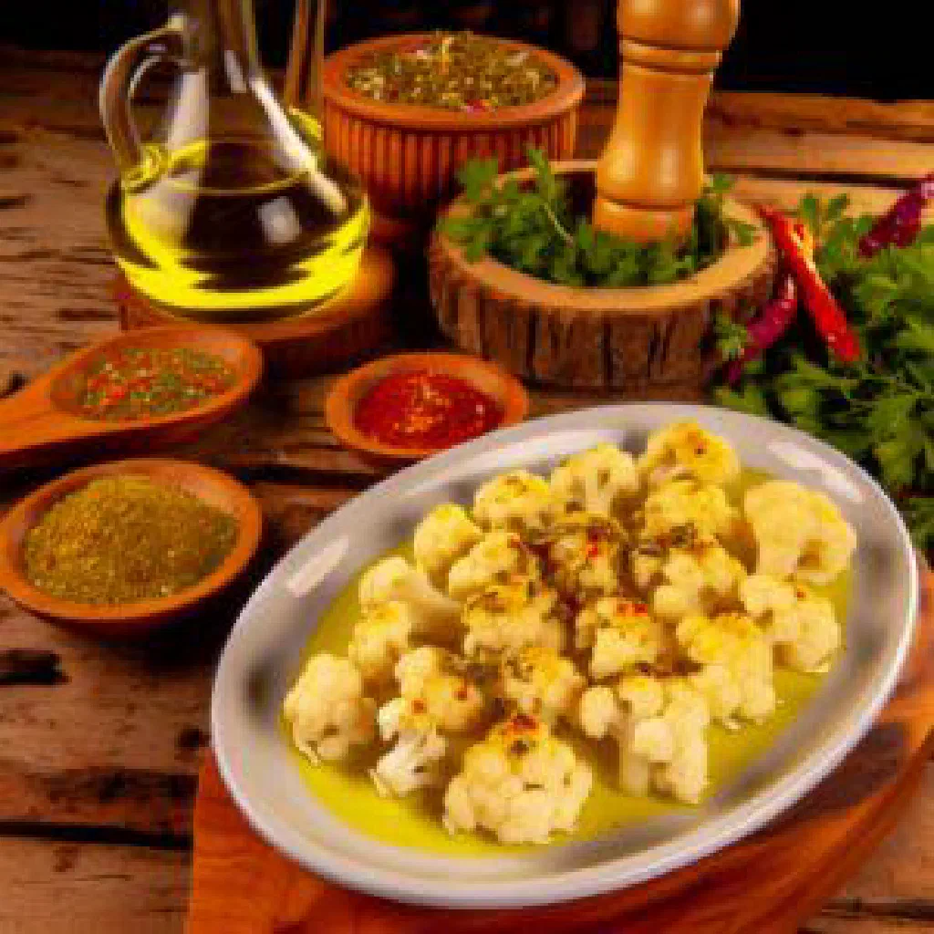 Olive oil braised cauliflower garnished with fresh dill and lemon