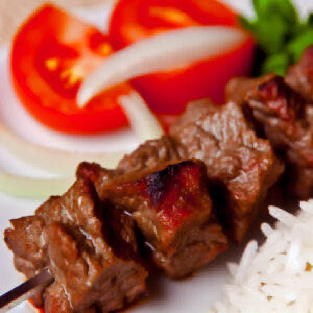 Grilled şiş kebab skewers with marinated meat and charred edges