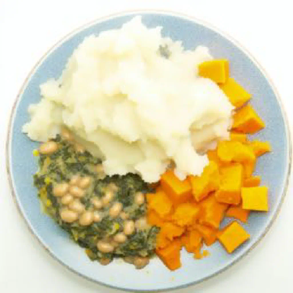 Smooth mound of Atapa served with a savoury sauce on the side