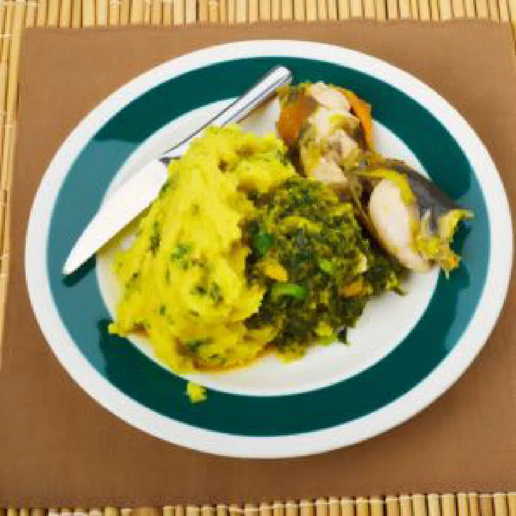 Bowl of Ugandan ekitobero stew with maize, beans and vegetables