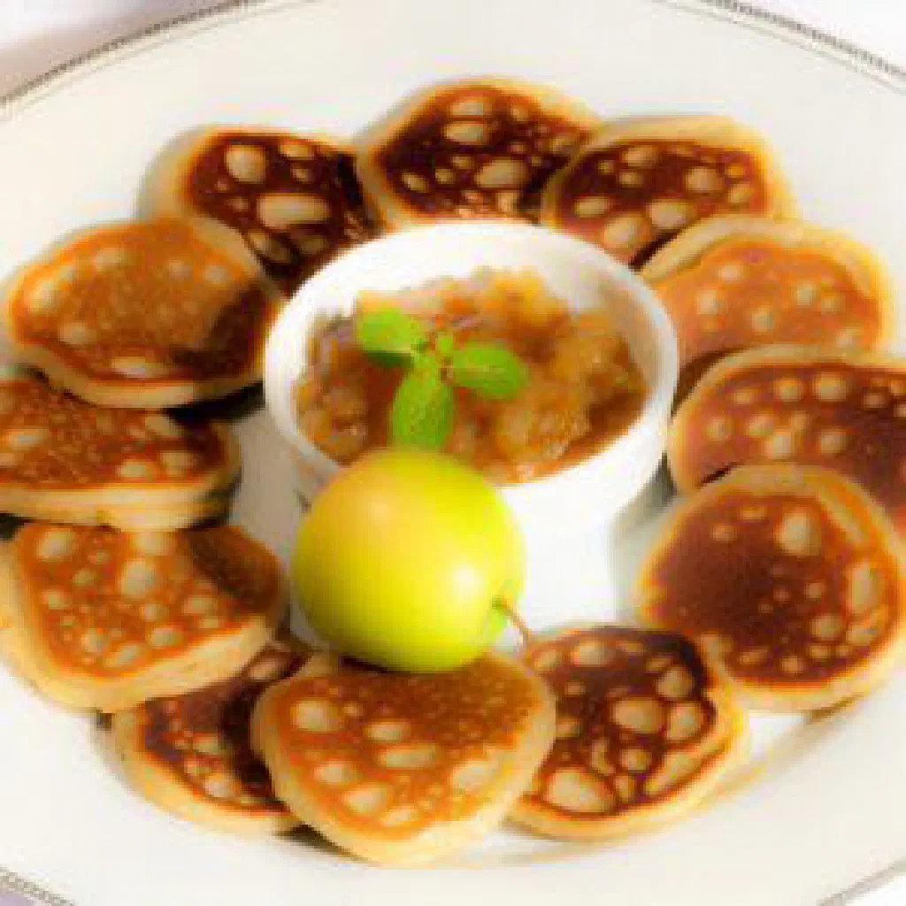 Freshly baked round Emirati khobz flatbread on a wooden board