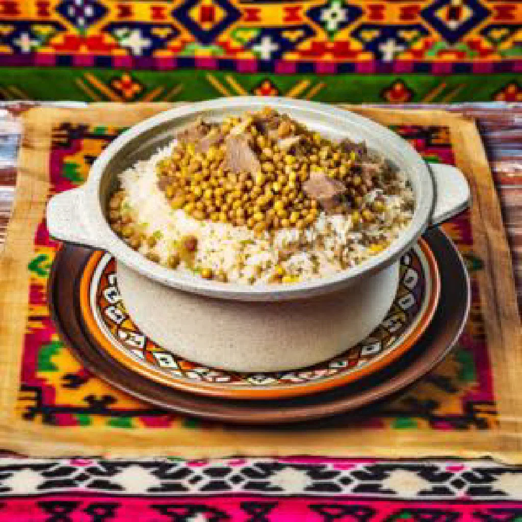 Bowl of Uzbek moshkichiri with rice, pulses and fresh herbs