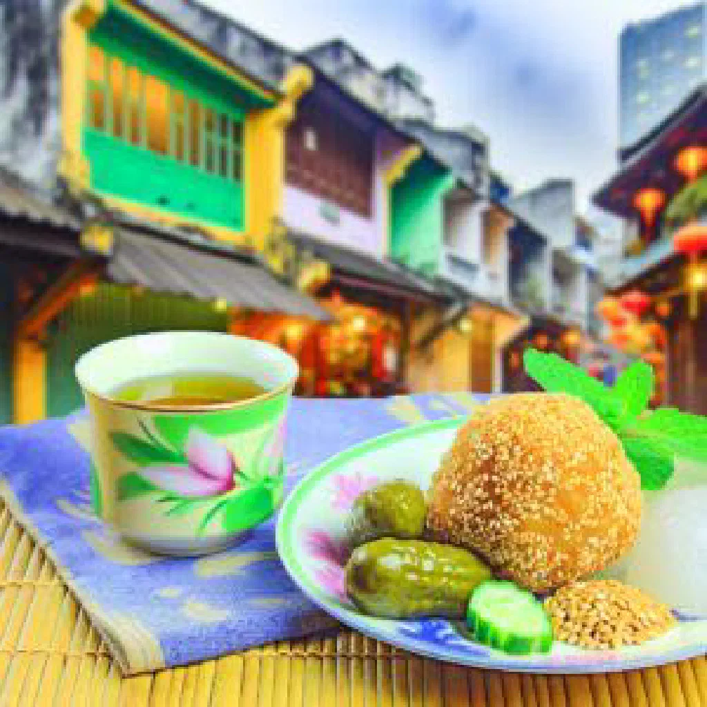 Golden fried Banh Ran sesame balls dusted with sugar on a plate