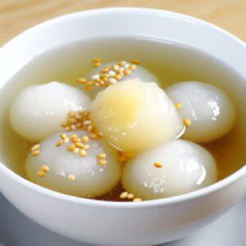 Che Troi Nuoc sticky rice balls in ginger syrup topped with coconut