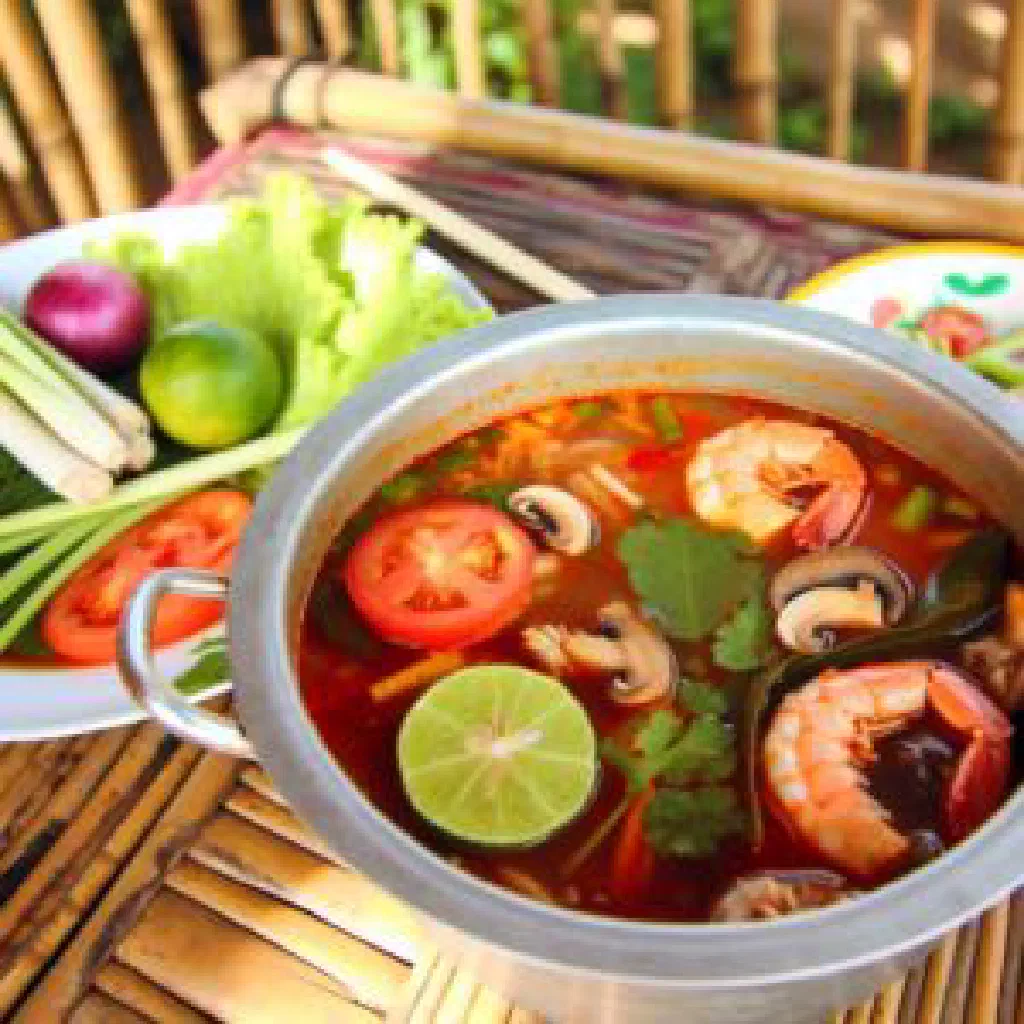Steaming Lau Tom Yum hotpot with prawns, squid and fresh herbs