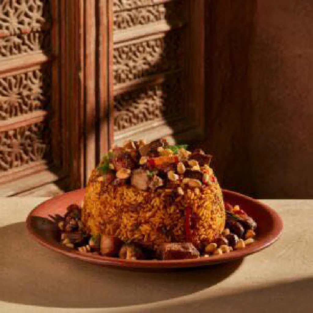 Braised Yemeni sabiha with tender spiced meat, fresh herbs and bread