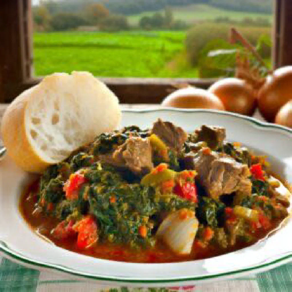 Zambian goatskin stew with tender goat meat, spinach and peanut sauce