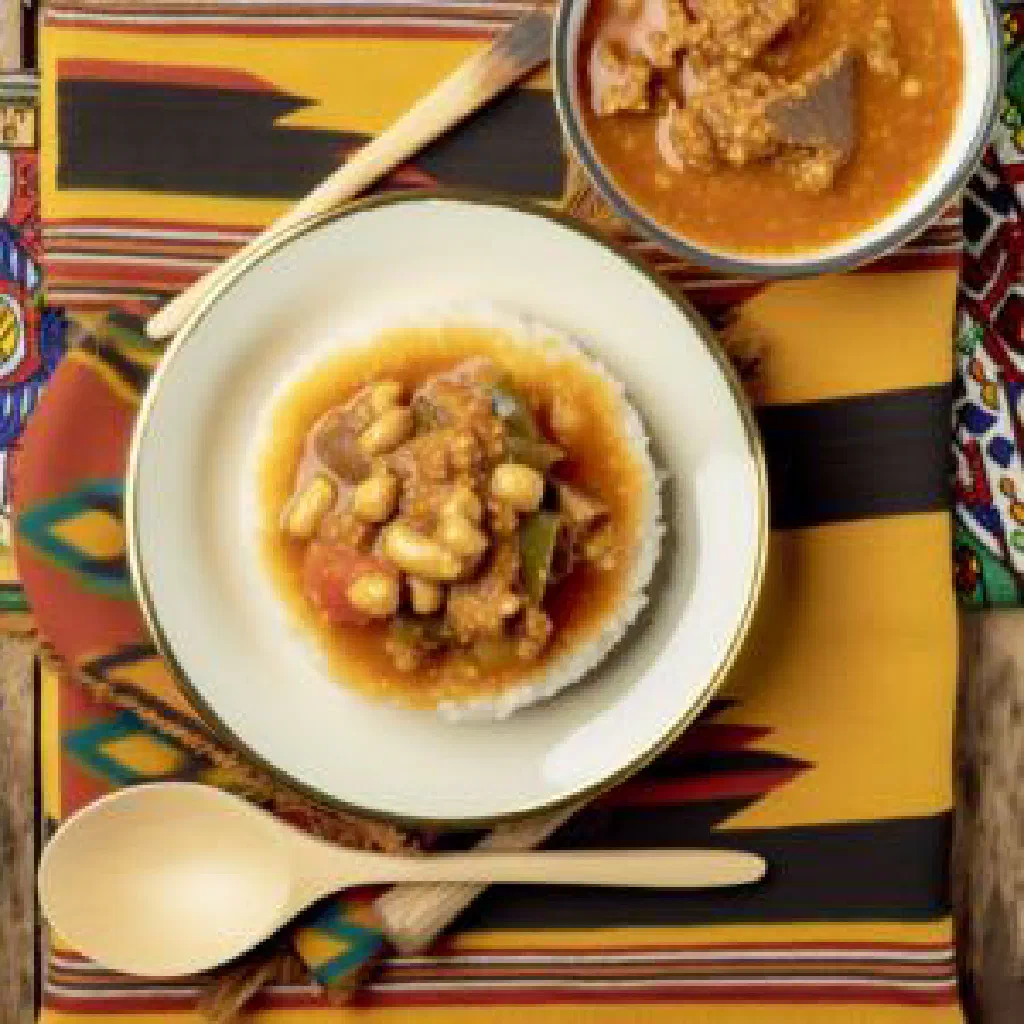 Bowl of creamy Zimbabwean hohwa porridge garnished with fresh herbs